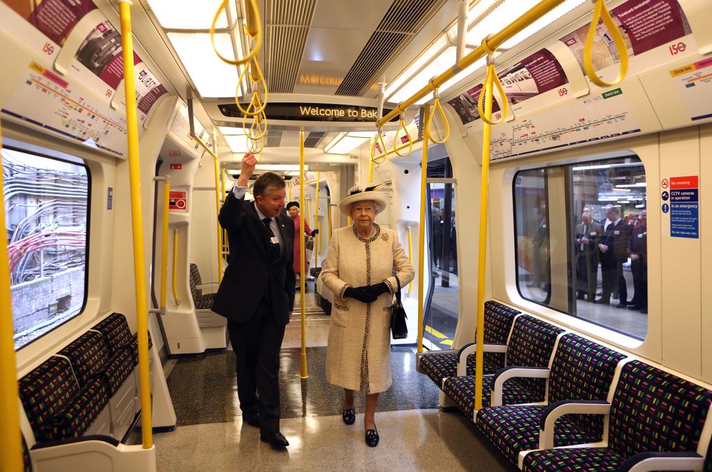Queen Elizabeth II boarding a tube on the London Underground to Baker Street