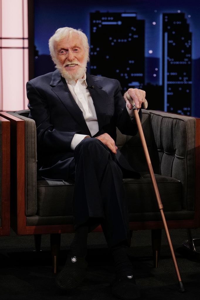Dick Van Dyke with cane sitting in chair