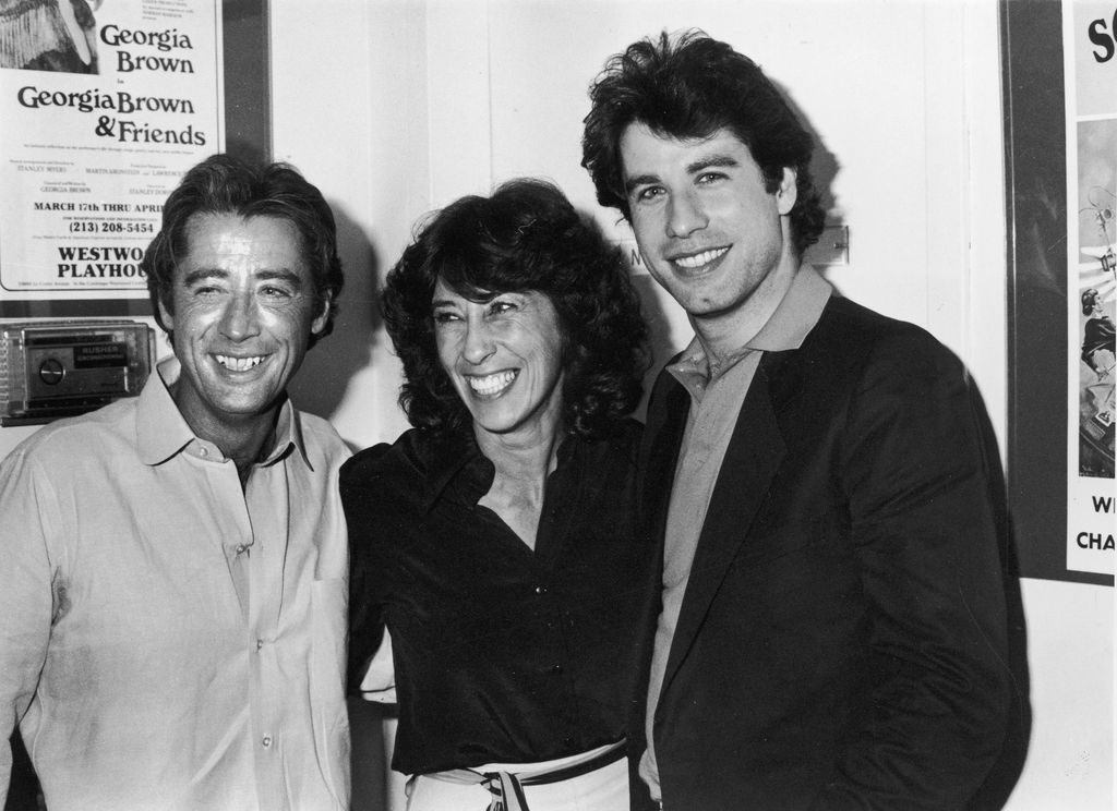  John Travolta poses with his sister Ellen Travolta, and his brother, Sam Travolta backstage in 1981 in a black and white photo