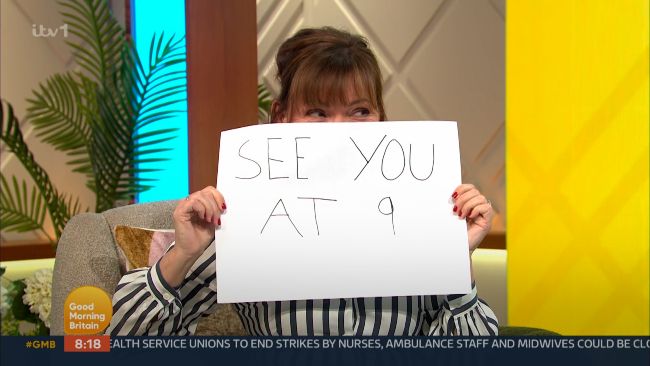 Lorraine Kelly holding a sign