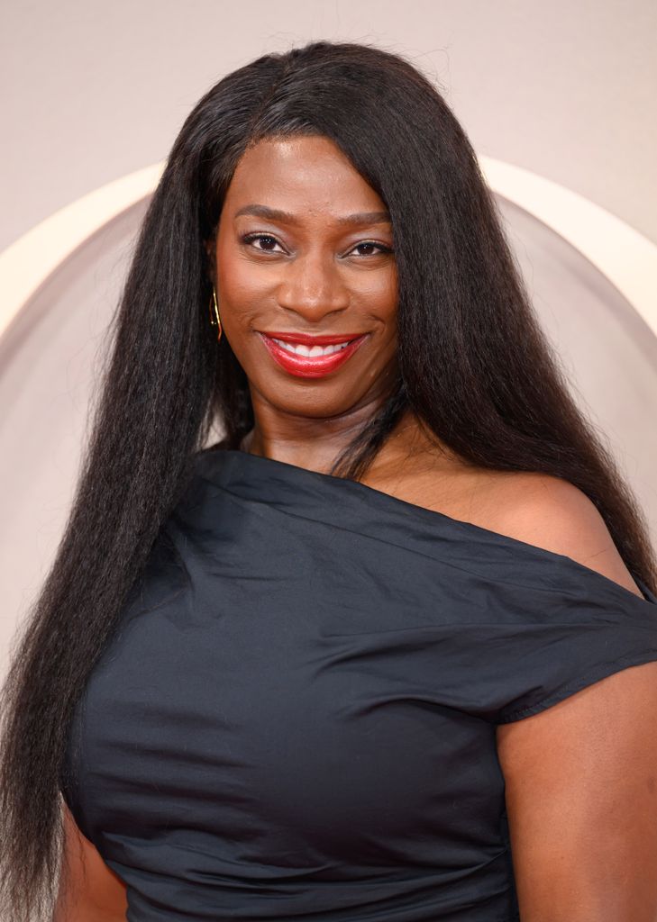 Tanya Moodie in an off the shoulder black top looking directly into the camera