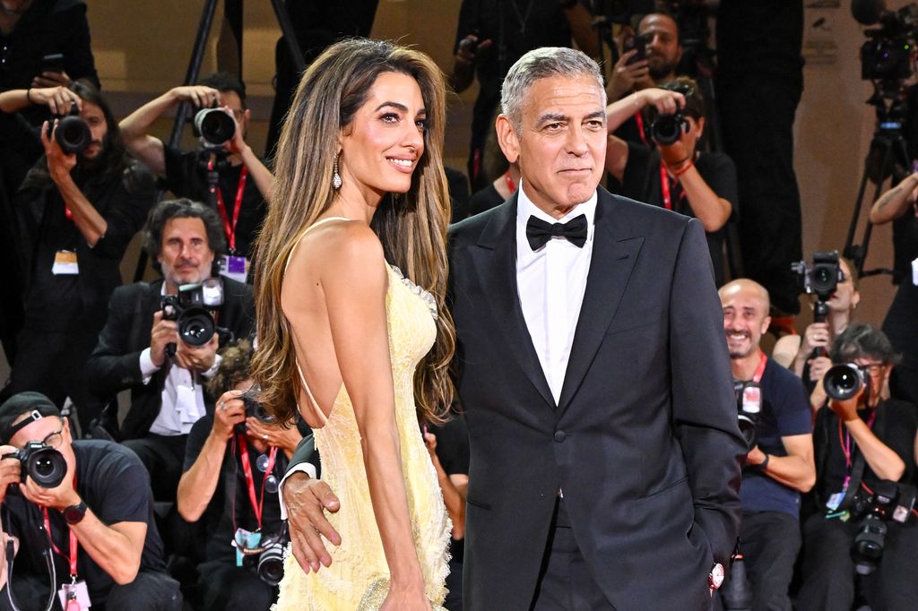 Amal Clooney and George Clooney attend the "Wolfs" red carpet during the 81st Venice International Film Festival