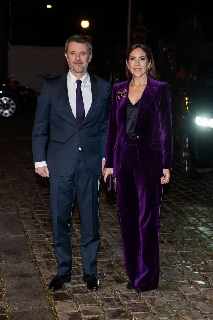 King Frederik in suit and Queen Mary in purple suit 