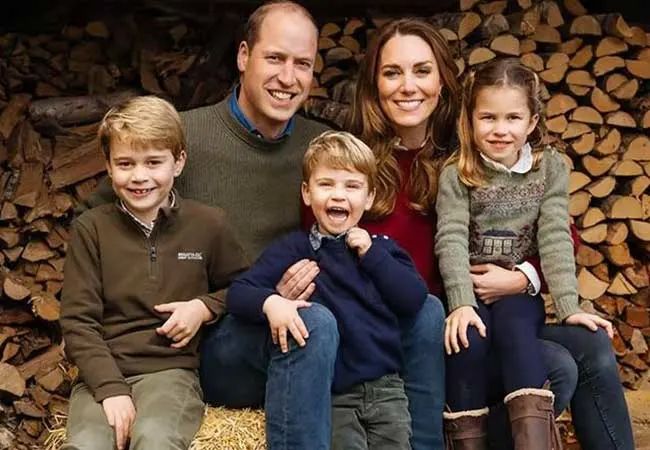 kate and william with kids outside home by log store