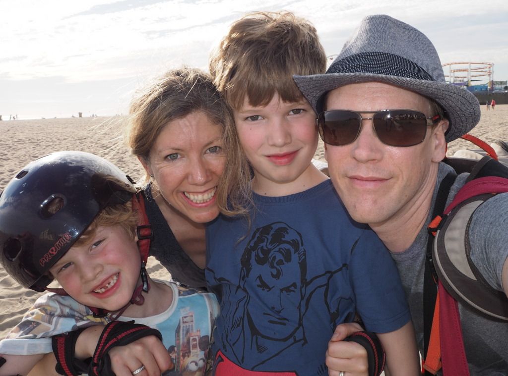 A family of four posing in a beach in America