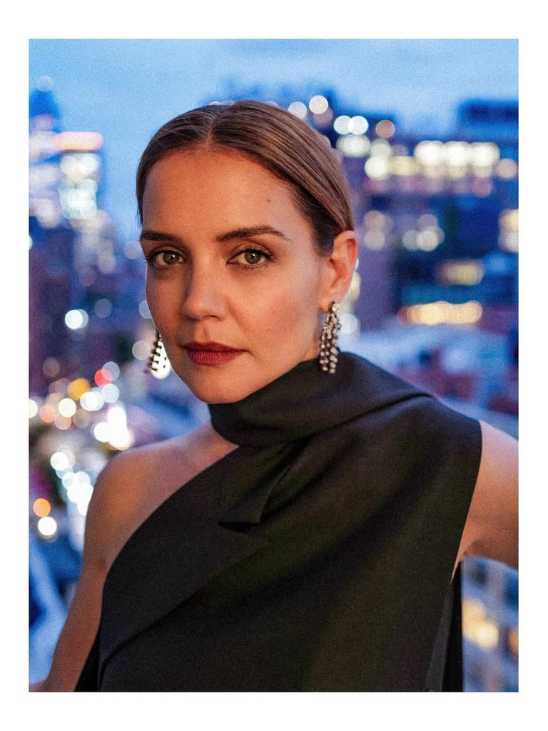 Katie Holmes in a silky black dress and red lip