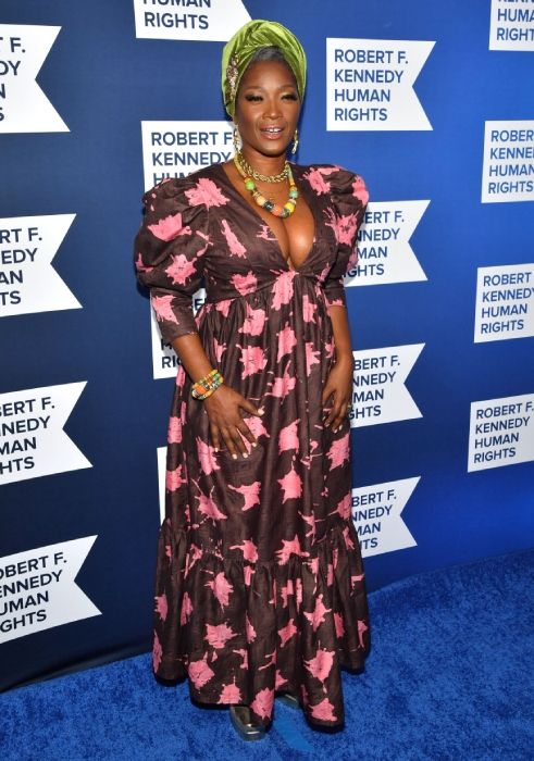 Yolanda Ross poses on blue carpet of Ripple of Hope awards