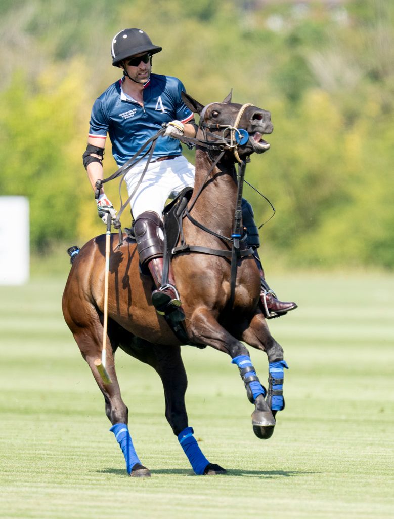 Prince William on a horse during polo match