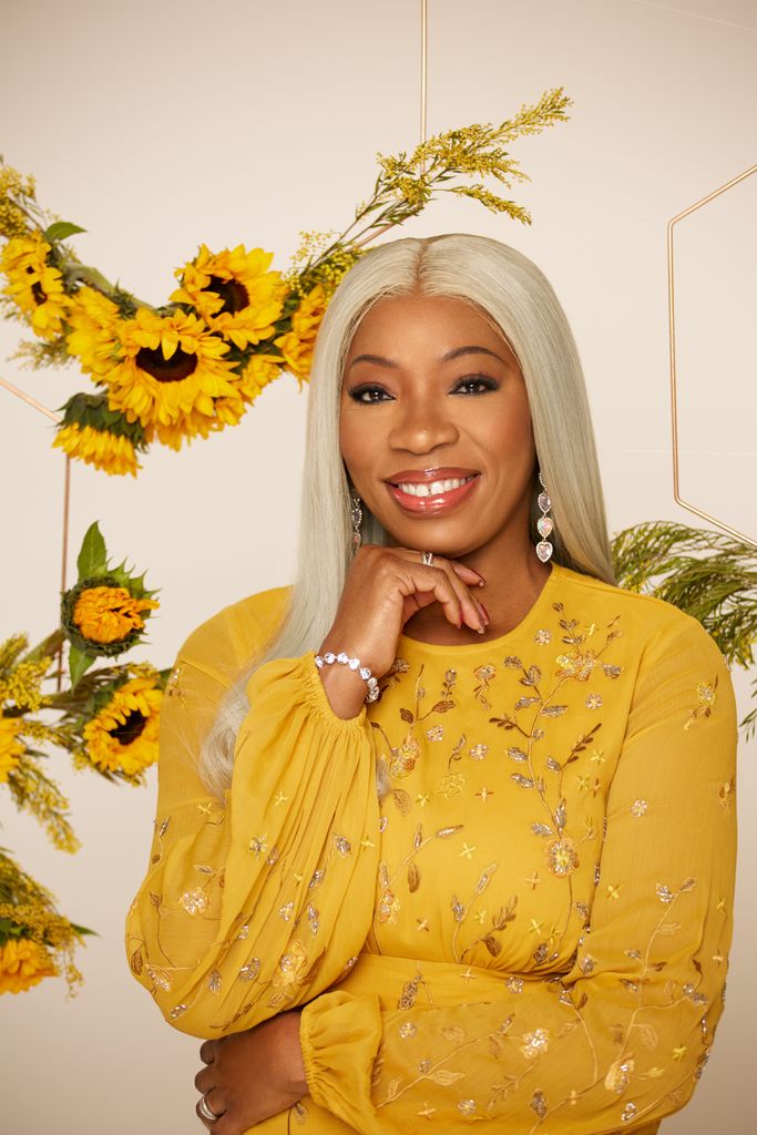 Tessy Ojo looks lovely in sunshine yellow dress as sunflower crowns hang behind her