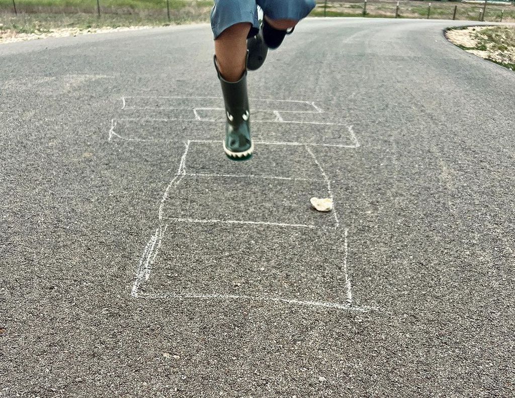 Joanna and Chip Gaines' son Crew in the middle of a game of hopscotch, shared by Joanna on Instagram