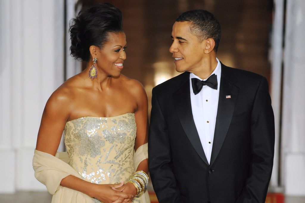 Michelle Obama in a strapless wedding dress with Barack Obama in a suit