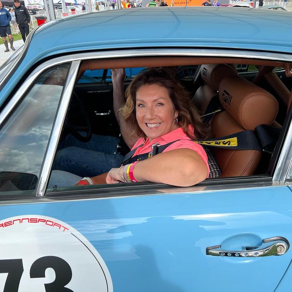 Close up of Jane McDonald smiling behind the wheel of a car