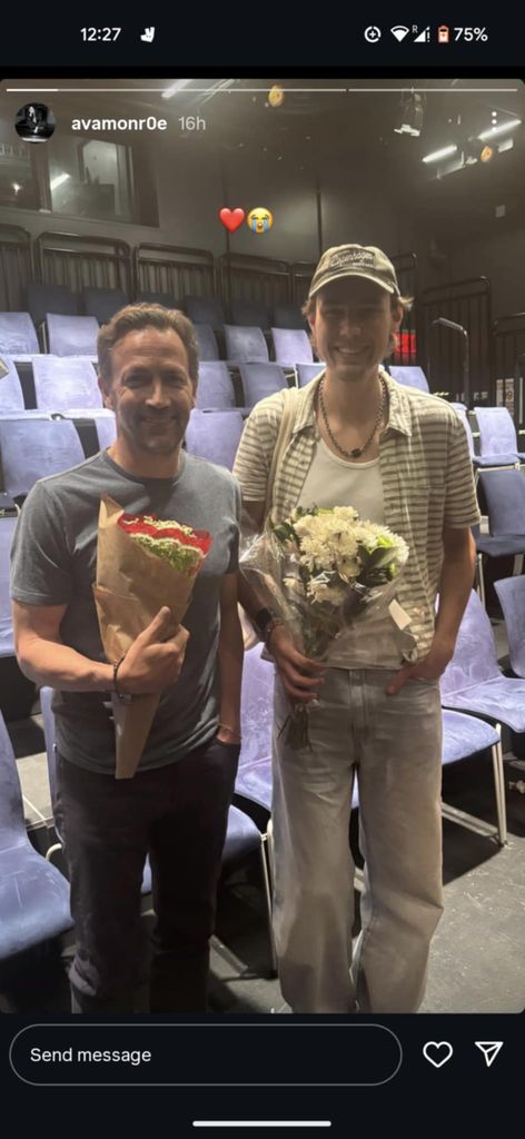 Amy Robach's ex Andrew Shue posing with a bouquet of flowers