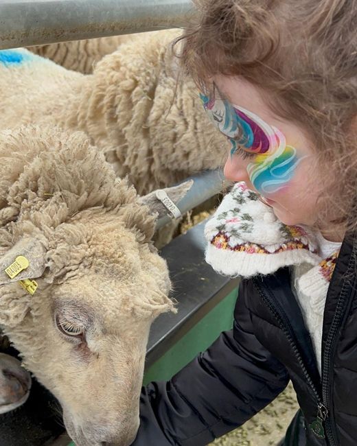 christine lampard daughter patricia with face paint on feeding sheep on farm