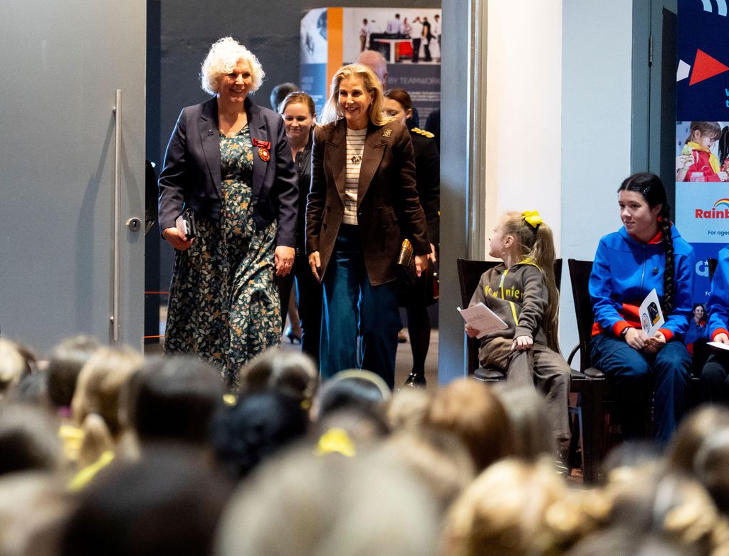 Duchess sophie entering room in striped top and brown blazer