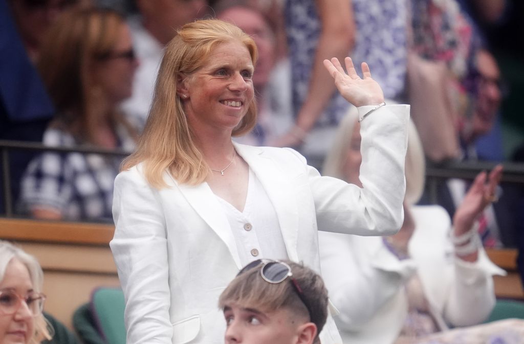 Rosalind Canter waving in white suit