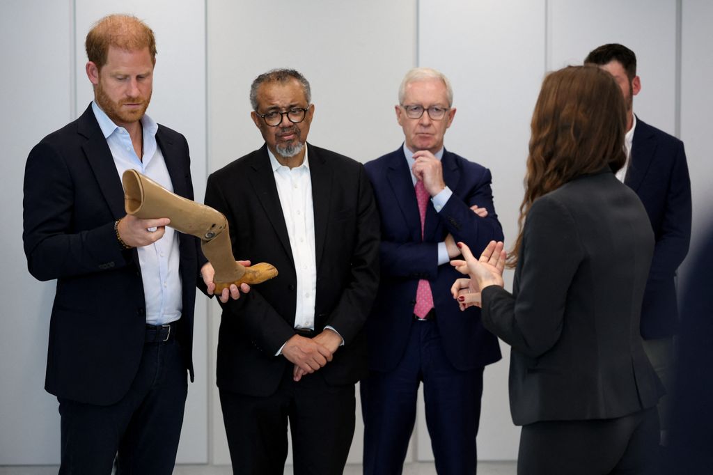 Prince Harry, Duke of Sussex examines a prosthetic limb as Director-General of the World Health Organization, Tedros Adhanom Ghebreyesus (2nd L) and Imperial College London Professor Hugh Brady (3rd L) look on during a visit to the Centre for Blast Injury Studies at Imperial College London