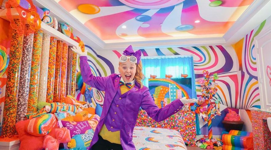 JoJo Siwa in a room surrounded by sweets