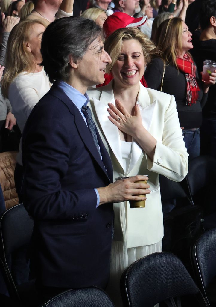 Greta Gerwig laughing with her new husband Noah Baumbach at Billy Joel's concert