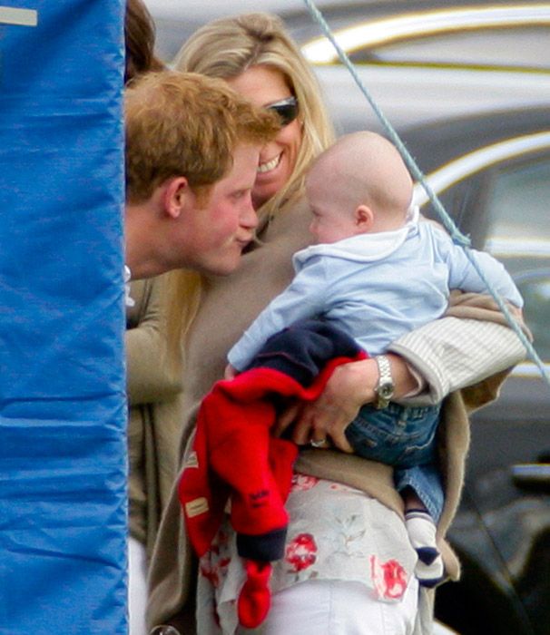 prince harry playing with friends baby