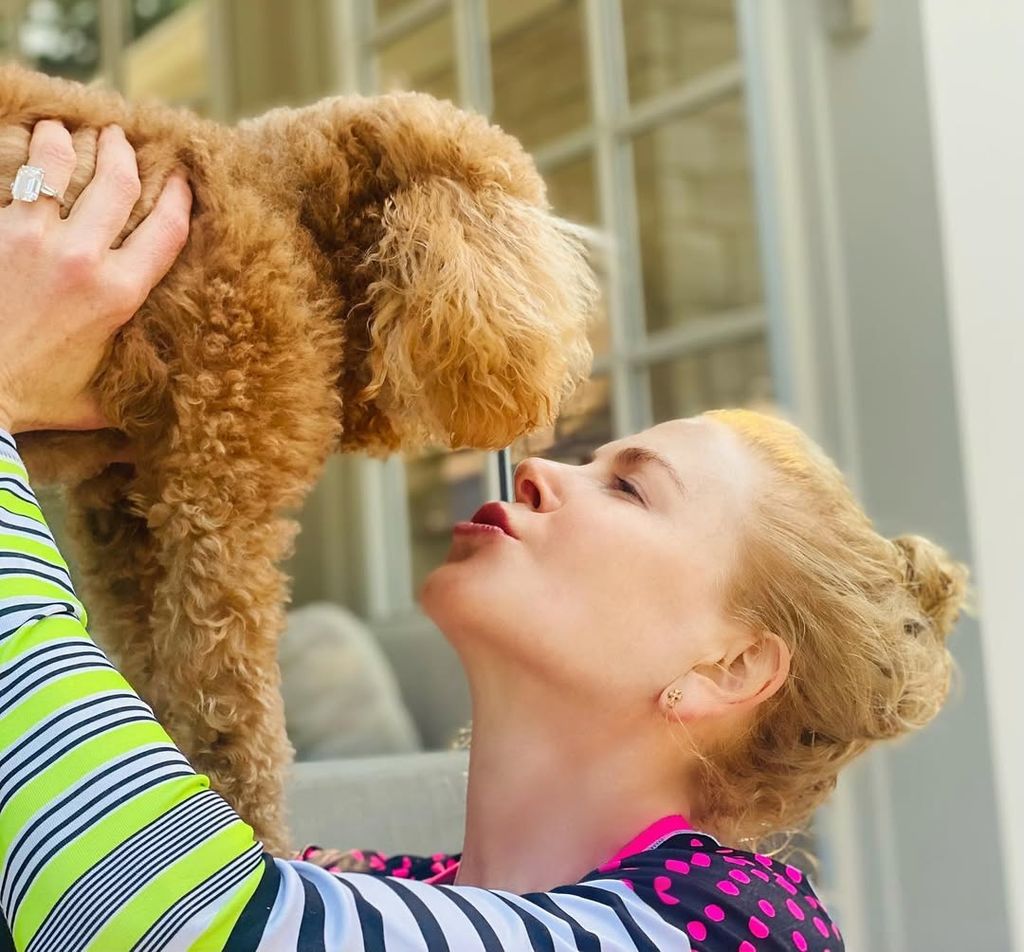 Nicole Kidman lifts up her dog for a kiss in the living room of her Beverly Hills home