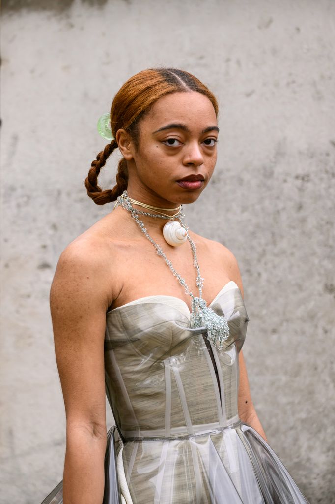 Damsel Elysium wears a Roksanda Ilincic dress and a shell necklace during London Fashion Week 