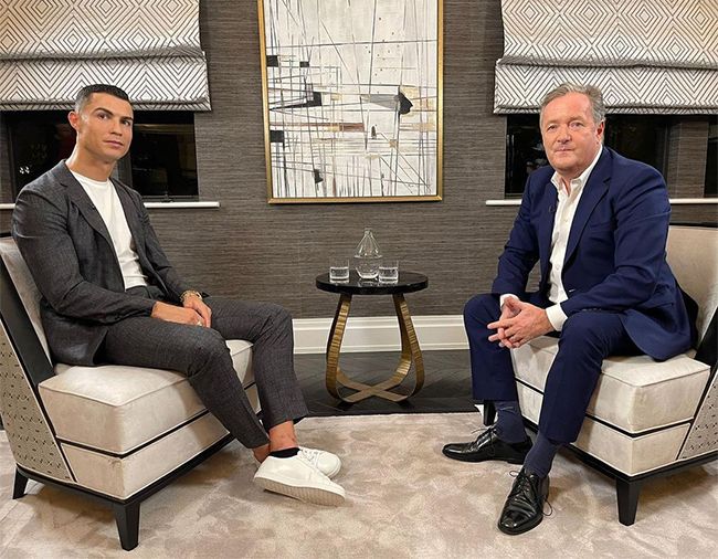 Cristiano Ronaldo posing alongside Piers Morgan during their interview