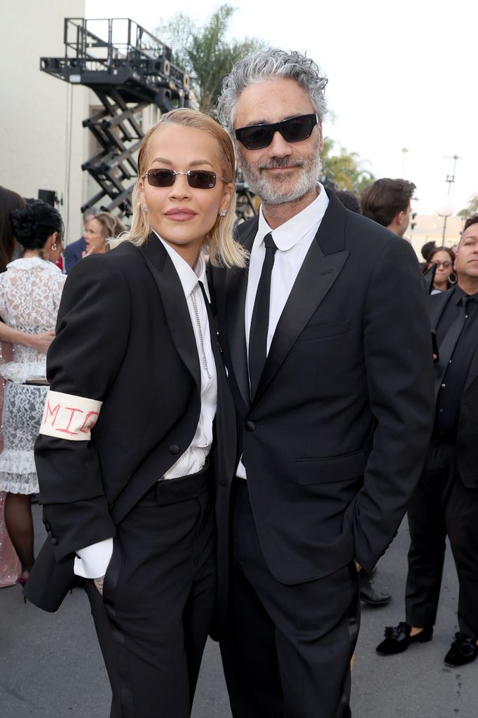 Rita Ora and Taika Waititi pose for photo in black suits while they attend Vogue World: Hollywood 2025 at Paramount Studios on October 26, 2025 in Los Angeles, California