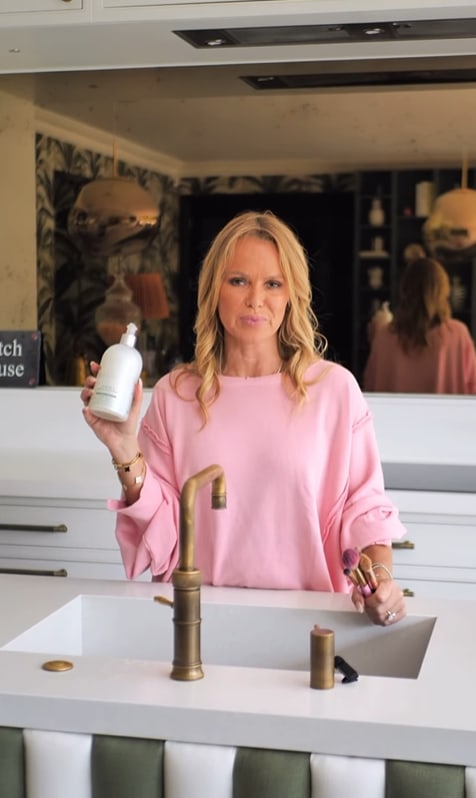 Amanda Holden standing at her sink in her kitchen holding soap and her makeup brushes