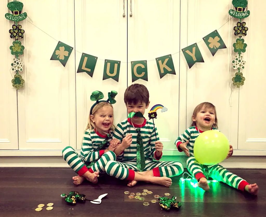 Vanessa Lachey's three kids sit in a row in green and white oneies