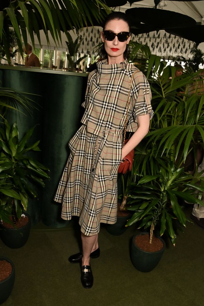Erin O'Connor in belted Burberry plaid dress with gloves and sunglasses at RHS Chelsea Flower Show 2025 Burberry dinner.