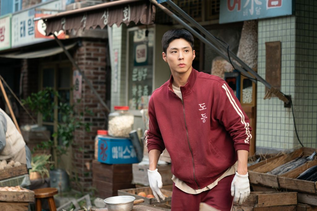 young man in tracksuit standing in street