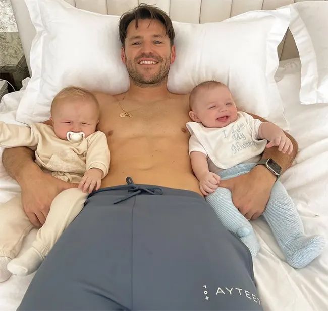 mark wright in bed with two babies