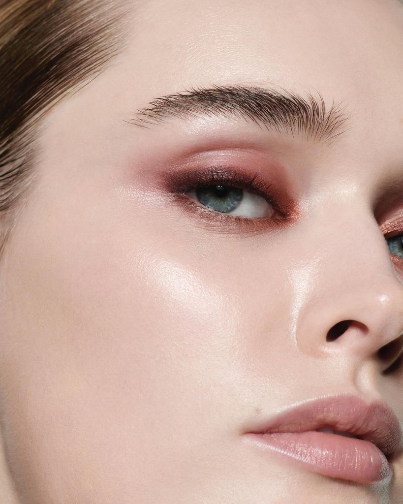close up a woman with clear skin and burgundy makeup