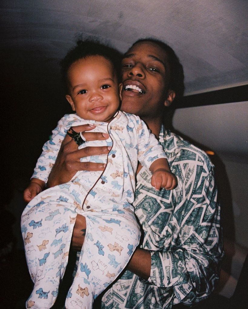 RZA rocks a baby grow with puppies on it as dad A$AP Rocky holds him