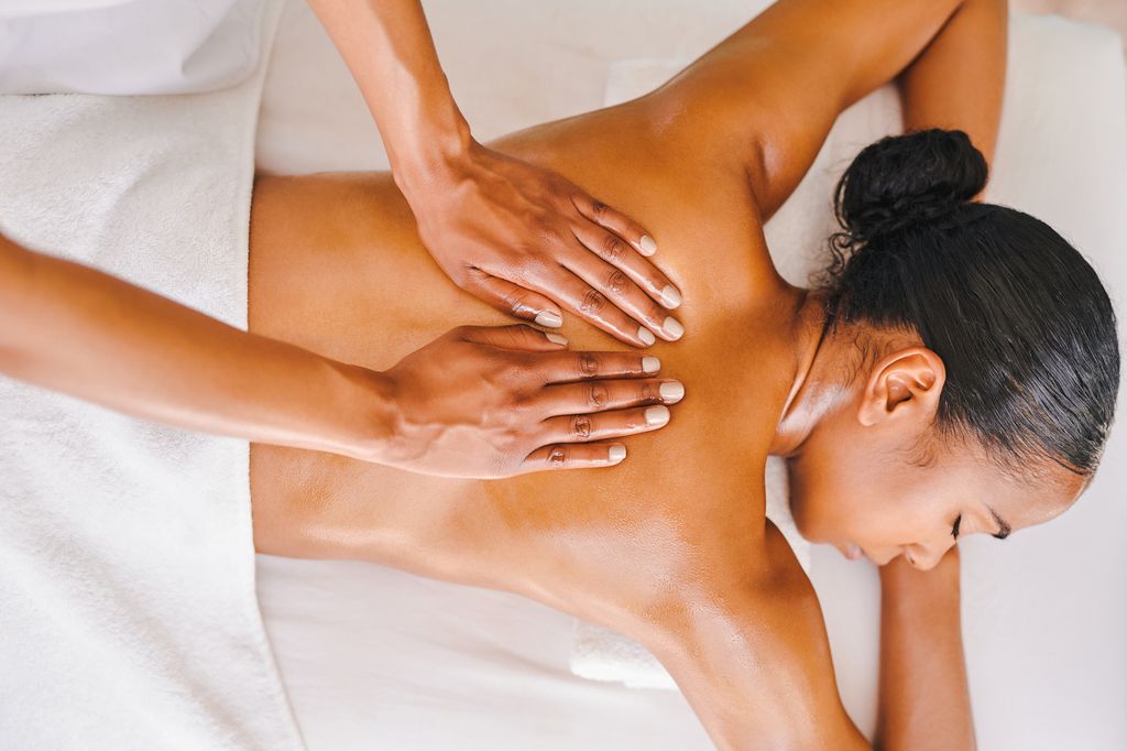 Shot of an attractive young woman getting a massage at a spa