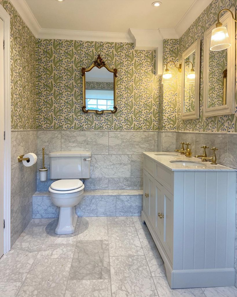 Frankie Rowan-Plowden's bathroom with marble floors and sage green wallpaper