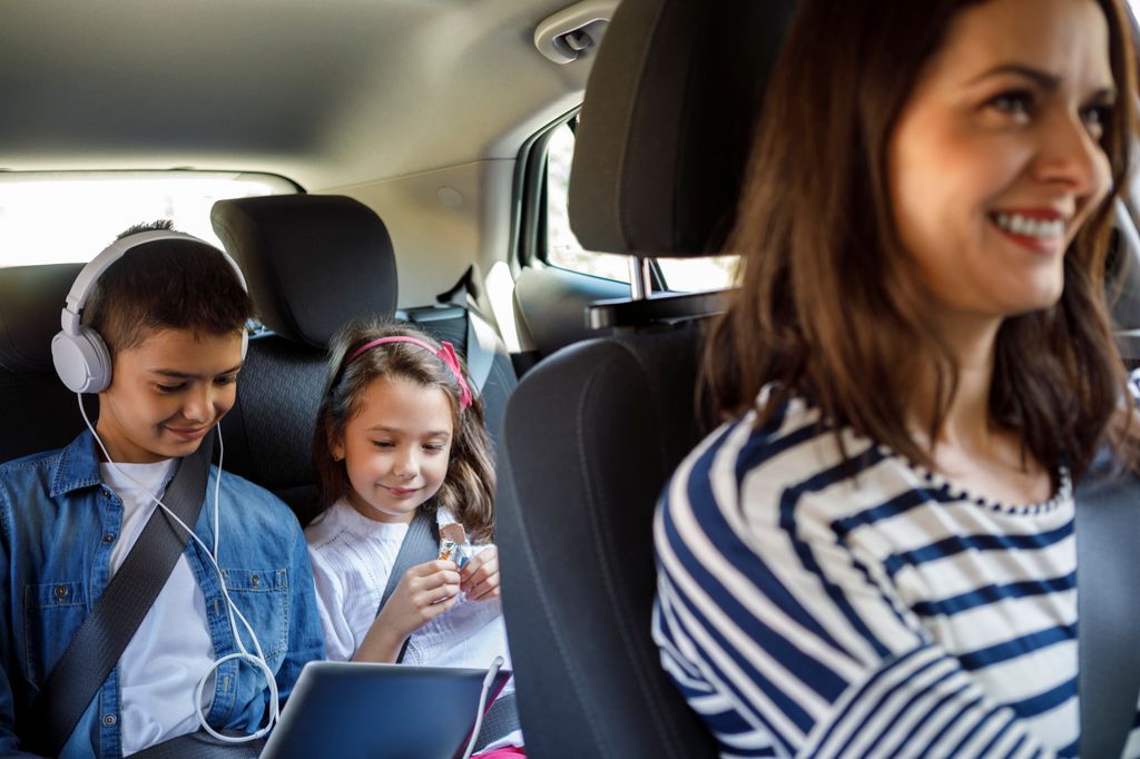 Mother and her children driving in the car together