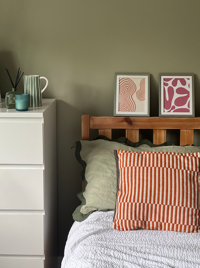 green bedroom with chest of drawers