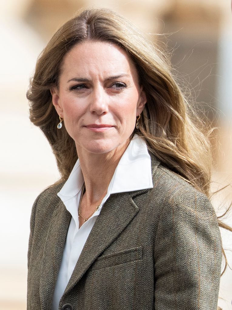 kate in blazer looking over shoulder