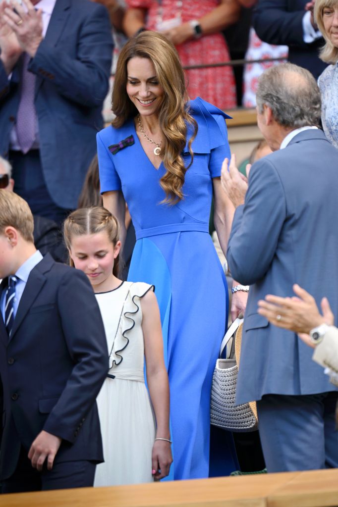 Catherine, Princess of Wales walking down royal box steps in blue dress