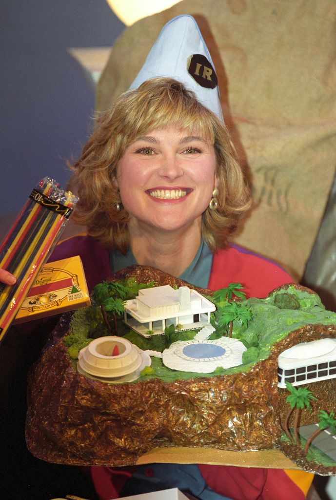 Blue Peter presenter Anthea Turner with a model of Tracy Island, the Thunderbirds Headquarters, made from household rubbish. The BBC closed their offer of a free 12 page leaflet on how to make the model after they received 100,000 letters requesting the instructions.   (Photo by Neil Munns - PA Images/PA Images via Getty Images)