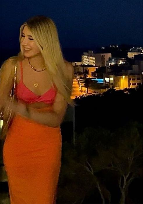 Phoebe Kay in orange dress