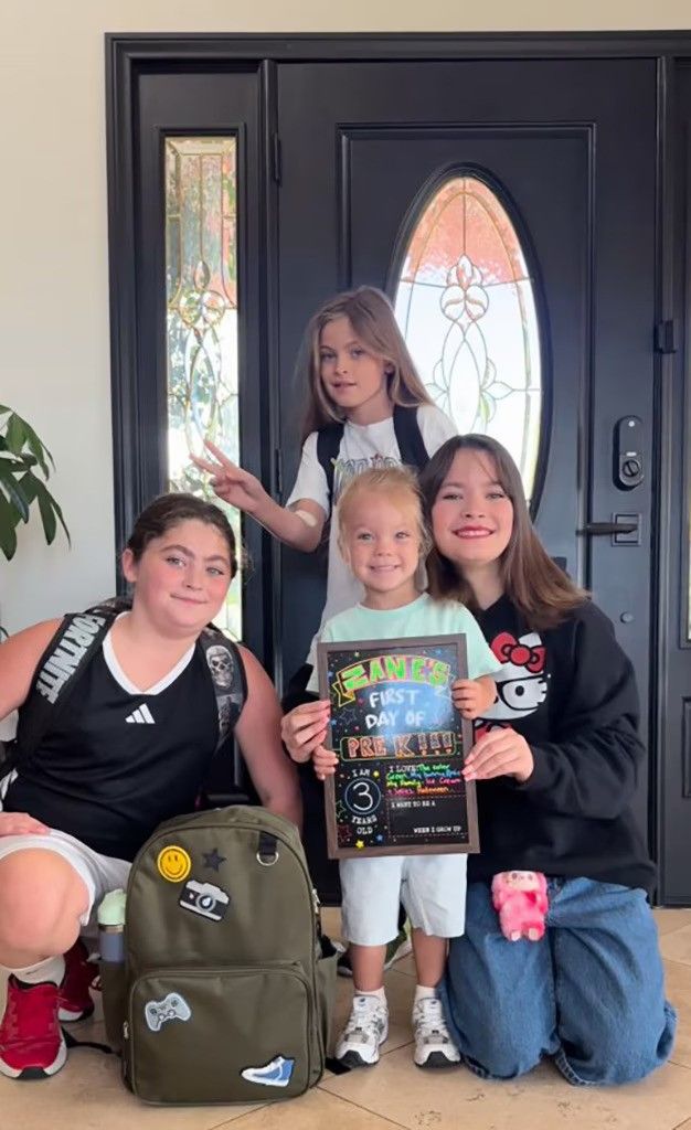 megan fox three kids posing with half brother zane by front door