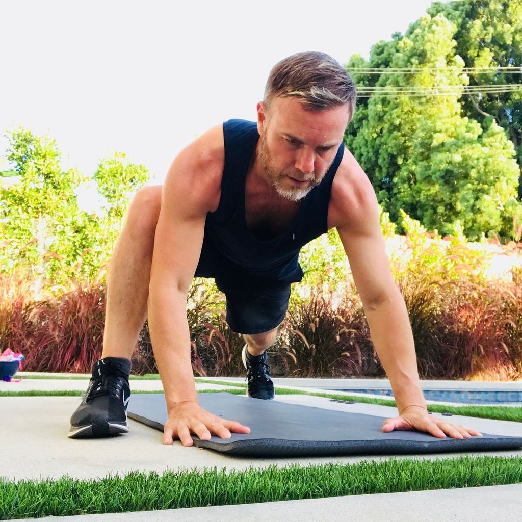 man peforming yoga stretch outside 