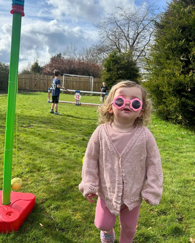 little girl in pink outfit with pink sunglasses 