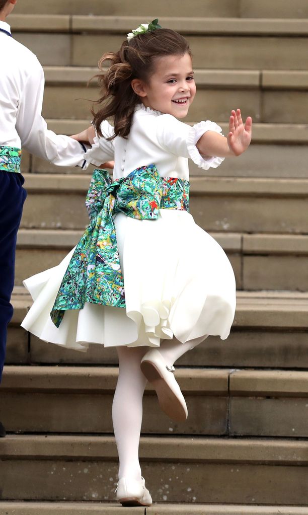 Theodora Williams waves as she arrives ahead of the wedding of Princess Eugenie of York and Mr. Jack Brooksbank at St. George's Chapel on October 12, 2018