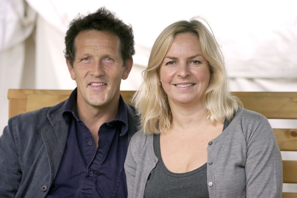 Monty Don and Sarah Don smiling sitting on a bench