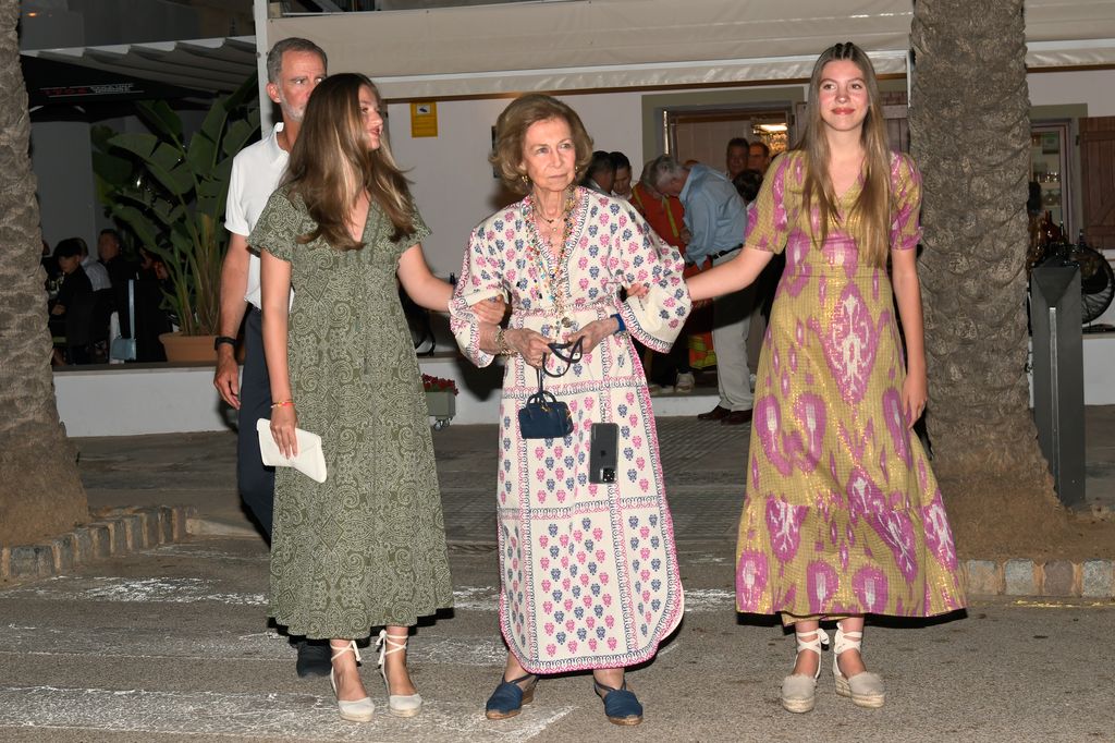 Princess Leonor and Infanta Sofia are both arm-in-arm with their grandmother Queen Sofia
