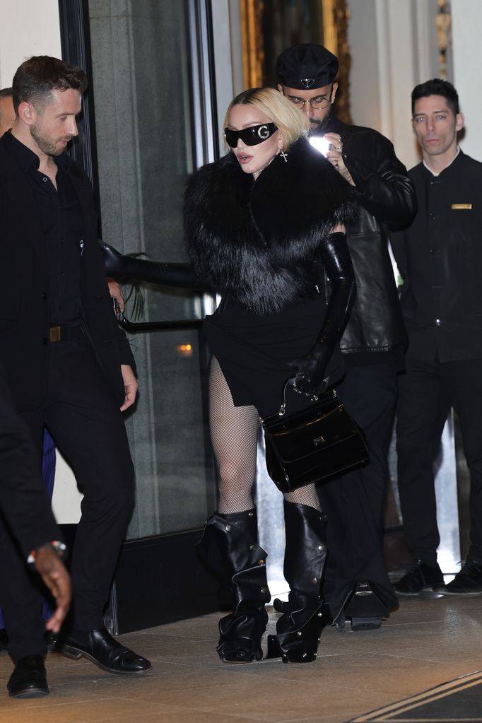 Madonna wearing black mini dress and fishnet tights